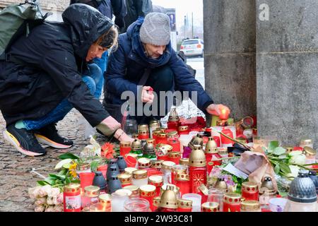 Prague, Czech Republic. 23rd Dec, 2023. People light candles outside the building of the Faculty of Arts of Charles University in Prague, the Czech Republic, Dec. 23, 2023. The Czech Republic on Saturday mourned the victims of a university shooting in the capital Prague that has left 14 people dead. On Thursday, a 24-year-old student from the faculty shot and killed 14 people before committing suicide. The tragic incident also left 25 others injured, among whom, three were foreigners, according to police. Credit: Deng Yaomin/Xinhua/Alamy Live News Stock Photo