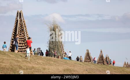 Reserve, USA. 23rd Dec, 2023. A group of bonfires line up the levee on ...