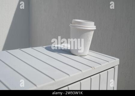Discarded  white takeaway paper cardboard cup for hot beverage Stock Photo