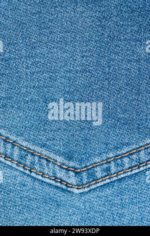 blue denim fabric made of cotton, details of a piece of clothing sewn from blue denim Stock Photo