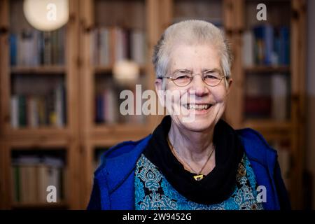 Berlin, Germany. 21st Dec, 2023. Elke Schilling, founder of Silbernetz, stands in her Berlin apartment. Silbernetz offers people aged 60 and over a sympathetic ear. You don't need a crisis or a problem to call - the desire to talk is enough. The people on the Silbertelefon listen, sympathize, encourage and can provide initial information. (to dpa: 'Silbernetz' hotline available around the clock over the holidays') Credit: Christoph Soeder/dpa/Alamy Live News Stock Photo