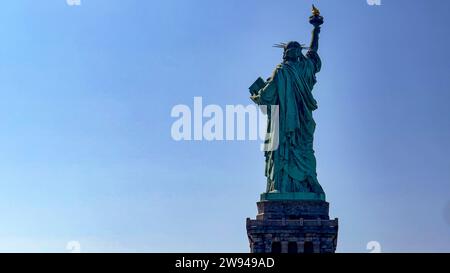 The famous Statue of Liberty of the Big Apple and Manhattan seen from the back, a monument known as the lady of New York all over the world. Stock Photo