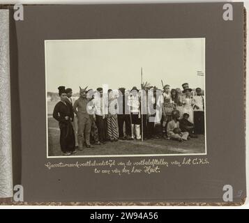 Costumed football teams from the Central Office for Statistics in Batavia, 1935 photograph Group photo of the costumed football teams of the Central Office for Statistics in Batavia at the match in honor of Mr. Hart. Photo Packed in the photo album offered by the staff of the Central Office for Statistics to Mr. Hart at his departure in 1935. Batavia photographic support   Batavia Stock Photo