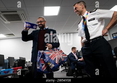 Home Secretary James Cleverly holds up a box of chocolates whilst meeting police officers at Luton Police Station to thank them for their service for working over the festive period. Picture date: Thursday December 21, 2023. Stock Photo