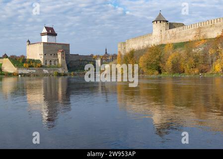 Ancient Herman's castle and Ivangorod fortress on the border river Narva on a sunny October day. Border between Russia and Estonia Stock Photo