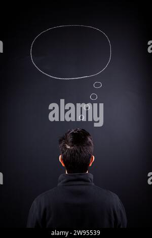 man looking to a blank thought on the chalkboard Stock Photo