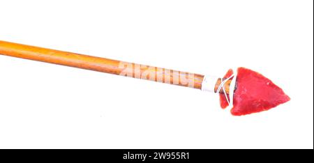 Handmade stone flint Arrow point isolated over a black background on a wooden shaft Stock Photo