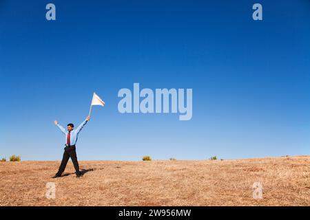 businessman asking for surrendering holding a white flag Stock Photo