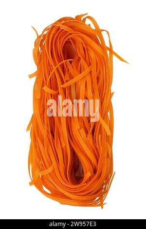 Homemade egg pasta tagliatelle with the addition of carrot. Raw nest noodles, uncooked ribbon fettuccine, dry long rolled macaroni isolated on white b Stock Photo