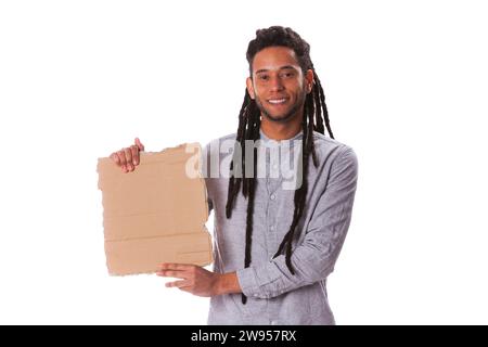 Happy young rastafari man holding a blank piece of cardboard Stock Photo