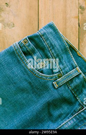 Close up of blue jeans ,Blue Jeans texture on wooden floor vintage filter Stock Photo