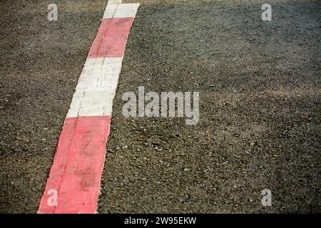 asphalt texture with red and white line marking Stock Photo