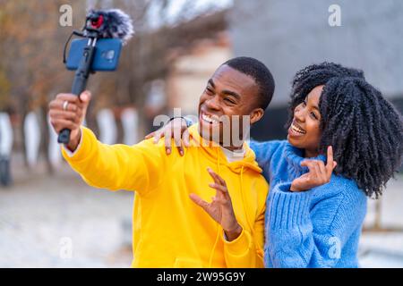 Two young african bloggers recording a video in the street Stock Photo