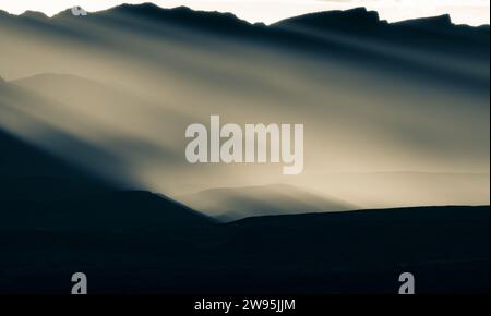 Rays of Sunlight Cast Over Silhouette of Sierra Del Carmen Range in Big Bend Stock Photo