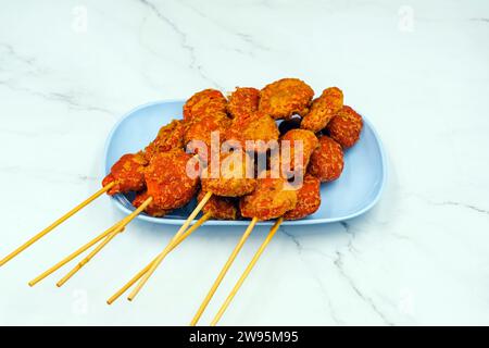 The delicious fried shrimp mixed with flour and seasonings on dish with marble background. Fried meatballs Made from meat. Asian Street Food. Deep fri Stock Photo