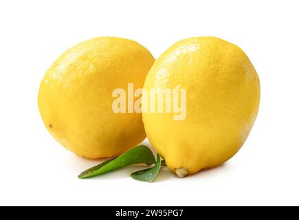 Two whole fresh beautiful yellow lemons with leaves are isolated on white background with clipping path. Stock Photo