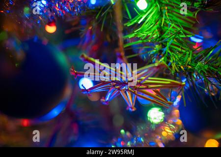 Kammlach, Bavaria, Germany - December 24, 2023: A colorfully decorated Christmas tree with Christmas baubles and colorful Christmas lights on an artificial Christmas tree on Christmas Eve *** Ein bunt geschmückter Weihnachtsbaum mit Christbaumkugeln und bunter Weihnachtsbeleuchtung an einem künstlichen Christbaum an Heilig Abend Stock Photo