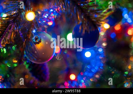 Kammlach, Bavaria, Germany - December 24, 2023: A colorfully decorated Christmas tree with Christmas baubles and colorful Christmas lights on an artificial Christmas tree on Christmas Eve *** Ein bunt geschmückter Weihnachtsbaum mit Christbaumkugeln und bunter Weihnachtsbeleuchtung an einem künstlichen Christbaum an Heilig Abend Stock Photo