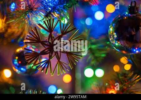 Kammlach, Bavaria, Germany - December 24, 2023: A colorfully decorated Christmas tree with Christmas baubles and colorful Christmas lights on an artificial Christmas tree on Christmas Eve *** Ein bunt geschmückter Weihnachtsbaum mit Christbaumkugeln und bunter Weihnachtsbeleuchtung an einem künstlichen Christbaum an Heilig Abend Stock Photo