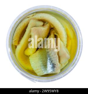 In plastic bucket containers are large pieces of salted herring fillet, freed from bones Stock Photo