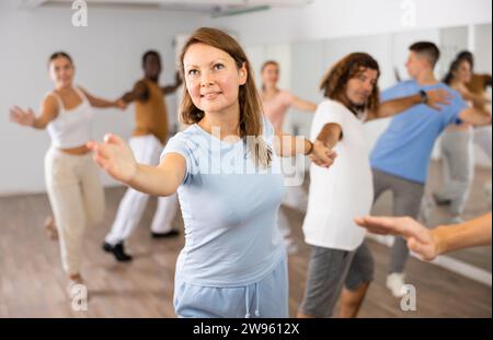 Adult couples dancing active dance together in studio Stock Photo