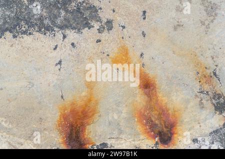 Abandoned old gray concrete wall or floor with rust spots or stripes was taken for use as decorative art background texture. Stock Photo