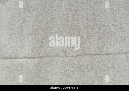 New gray or brown bath towel with long stripe is taken for use as background or texture in art work. Stock Photo