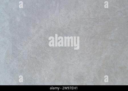 Unfinished facing wall with strange scratches in home or residence building, gray cemented wall is used as background texture. Stock Photo