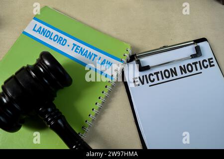 Concept of Eviction Notice on document form and book landlord-Tenant law isolated on Wooden Table. Stock Photo