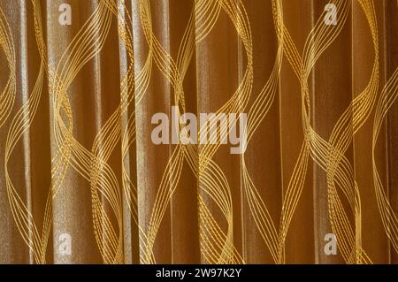 Brown curtain background texture with beautiful pattern was taken in hotel room. Clothing background texture, dark red fabric with vertical pattern Stock Photo
