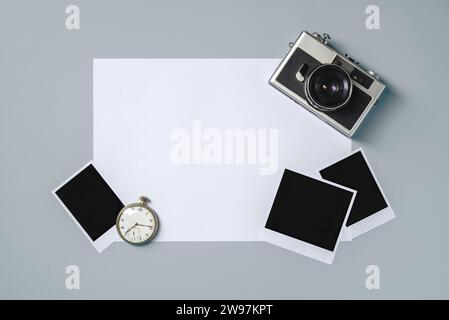 Vintage photo camera and empty photo frames on grey background. Travel moment concept Stock Photo