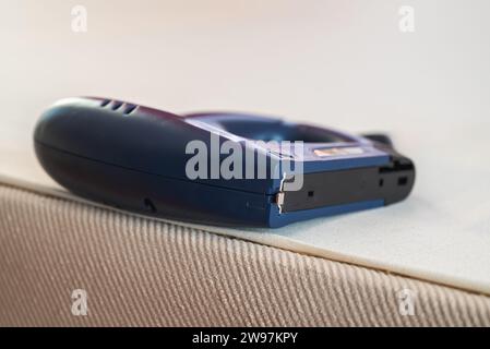 Worker stapling sofa lining with electric staple gun Stock Photo
