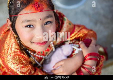 Bhaktapur, Bagmati, Nepal. 25th Dec, 2023. Portrait of a girl during Gufa ceremony in Bhaktapur on Monday. In this ceremony, the girls of Newar community aged between 12-14 years of age are married to Sun God before her first mensuration. The girl carrying the ritual must reside for 12 days while avoiding the Sun and the male members of the family. After the completion of the process, on 12th day, the girl is taken out of the room and asked to look at the sun. (Credit Image: © Amit Machamasi/ZUMA Press Wire) EDITORIAL USAGE ONLY! Not for Commercial USAGE! Stock Photo