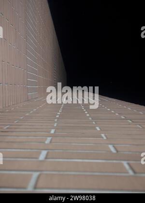 A tiled wall surface against a dark background Stock Photo