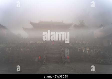 Purple Heaven Palace is a Taoist temple complex located in Wudang Mountain, China. The temple is shrouded in mist, creating a mysterious and spiritual Stock Photo