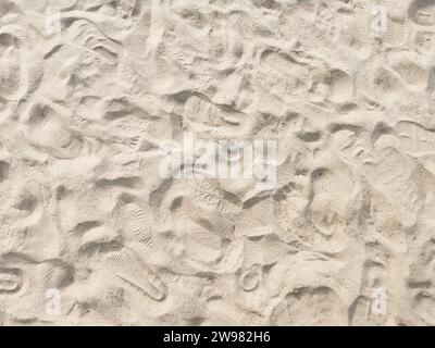 Dry sand creating an abstract textured background with shadows and light Stock Photo