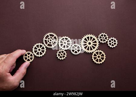 Business process and workflow automation with flowchart. Hand holding wooden cog flowing process management. Stock Photo