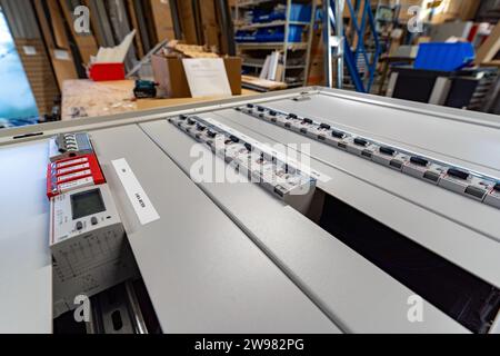 A variety of switches in an electronic cabinet Stock Photo