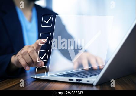 Businessman touch on digital screen check correct sign mark in checkbox for quality document control checklist for business approve. Stock Photo