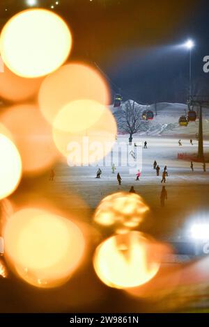 (231225) -- JILIN, Dec. 25, 2023 (Xinhua) -- This photo taken on Dec. 14, 2023 shows people enjoying winter sports at Lake Songhua Resort in Jilin City, northeast China's Jilin Province. As winter falls, the Swiss town of Zermatt and China's Jilin entered their peak season for tourists. Thanks to the landscape that overlooked by the Matterhorn Mountain, one of the natural symbols of Switzerland in the Alps, Zermatt attracts masses of worldwide winter-lovers. Based on winter activities, a full chain of tourism industry has been built in Zermatt, including catering, shopping, hiking, accommo Stock Photo