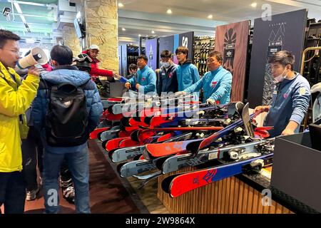 (231225) -- JILIN, Dec. 25, 2023 (Xinhua) -- This photo taken on Dec. 5, 2023 shows staff members distributing winter sports equipment at Lake Songhua Resort in Jilin City, northeast China's Jilin Province. As winter falls, the Swiss town of Zermatt and China's Jilin entered their peak season for tourists. Thanks to the landscape that overlooked by the Matterhorn Mountain, one of the natural symbols of Switzerland in the Alps, Zermatt attracts masses of worldwide winter-lovers. Based on winter activities, a full chain of tourism industry has been built in Zermatt, including catering, shopp Stock Photo