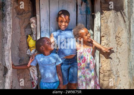 portrait of group of african children in the village, standing in front of door of the hut in an informal settlement Stock Photo