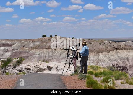 A man and woman with each a camera and tripod making photography on the Blue Mesa Trail in Petrified Forest National Park Stock Photo