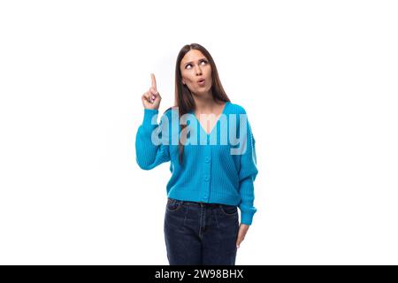 inspired successful cute young woman dressed in blue cardigan Stock Photo