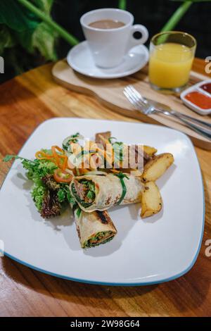 A plate of food served in a dish on the table with drinks and sauces. Stock Photo