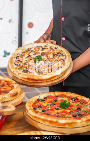 A person holding a pizza Stock Photo