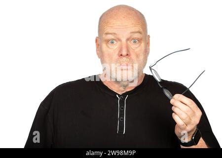 Surprised Middle-Aged Caucasian Man Holding Dark Eyeglasses Frame on White Background - Shocked Expression Stock Photo