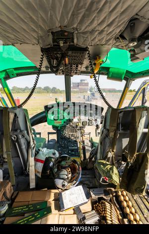 Interior, 1960's US decommission Bell Huey UH1 Iroquois Helicopter. Pilot and co-pilot's seat with flight controls. Ammo in front. Used in Vietnam. Stock Photo
