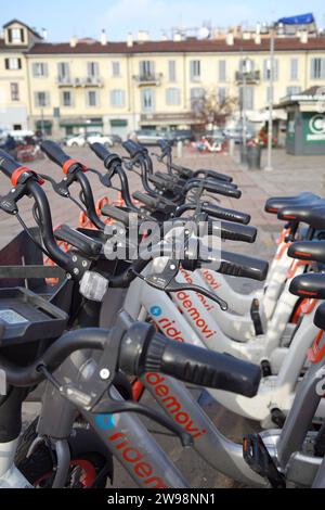 Hire Bikes lined up in a row in public in Milan, Italy Stock Photo