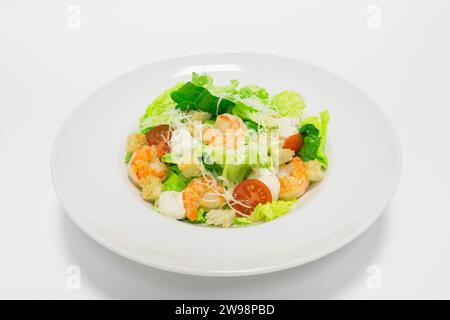 Gourmet salad with tiger prawns, cherry tomatoes and croutons. Top view. White background. Healthy eating concept. Mixed media Stock Photo